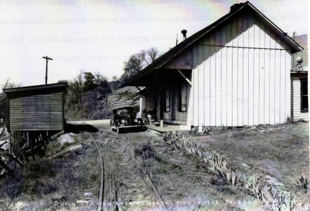 This picture circa 1938 of the "station" at Dunnas Station the location of my childhood and formative years.  The building housed the station of a narrow gauge railroad, a post office and a general store.  On the left is a small warehouse.